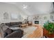 Light-filled living room featuring vaulted ceilings, hardwood floors, a fireplace, and a large sectional sofa at 9607 Kings Grant Dr., Murrells Inlet, SC 29576