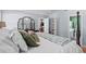 Comfortable bedroom showcasing a bed with decorative pillows and a view into the ensuite bathroom and closet at 9607 Kings Grant Dr., Murrells Inlet, SC 29576