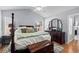 Cozy main bedroom with vaulted ceiling, wood floors, and a comfortable four-poster bed at 9607 Kings Grant Dr., Murrells Inlet, SC 29576