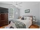 Cozy bedroom with natural light, plush bedding, a dresser with a TV, and coordinated decor at 9607 Kings Grant Dr., Murrells Inlet, SC 29576