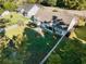 Aerial view of fenced backyard, complete with a covered patio, lush green lawn and mature shade trees at 100 Woodlyn Ave., Little River, SC 29566