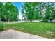 Lush backyard with a white fence and manicured lawn, ideal for recreation and relaxation at 100 Woodlyn Ave., Little River, SC 29566
