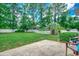 Expansive backyard featuring a well-manicured lawn, a white fence, and lush greenery at 100 Woodlyn Ave., Little River, SC 29566