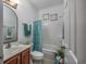 Bathroom featuring a single sink vanity, toilet, and a shower/tub combo with curtain at 100 Woodlyn Ave., Little River, SC 29566