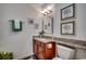 Charming half-bathroom with granite countertops, decorative wall art, and stylish fixtures at 100 Woodlyn Ave., Little River, SC 29566