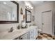 Bathroom featuring double sinks, white cabinets, and stylish mirrors at 100 Woodlyn Ave., Little River, SC 29566
