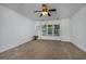 Spacious bedroom with carpet, ceiling fan, and large windows allowing ample light at 100 Woodlyn Ave., Little River, SC 29566