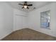 Bedroom featuring a ceiling fan, neutral carpet, and a closet for ample storage at 100 Woodlyn Ave., Little River, SC 29566