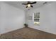 Bright bedroom with neutral carpet, ceiling fan, and a window allowing plenty of natural light at 100 Woodlyn Ave., Little River, SC 29566