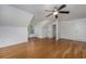 Spacious bedroom featuring wood floors, natural light, and a modern ceiling fan at 100 Woodlyn Ave., Little River, SC 29566