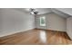 Light-filled bedroom featuring hardwood floors, neutral walls, and a large window at 100 Woodlyn Ave., Little River, SC 29566