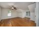 Spacious bedroom with hardwood floors, two windows, and a ceiling fan at 100 Woodlyn Ave., Little River, SC 29566