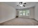 Bright bedroom with neutral carpeting, large windows, and ample space at 100 Woodlyn Ave., Little River, SC 29566