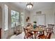 Cozy dining area with a round table, natural light, and decorative accents at 100 Woodlyn Ave., Little River, SC 29566