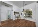 Bright dining room with hardwood floors, a chandelier, and access to a bathroom at 100 Woodlyn Ave., Little River, SC 29566