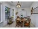 Charming dining area with tiled flooring, round table, and ample natural light at 100 Woodlyn Ave., Little River, SC 29566