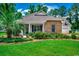 Attractive single-story home with stone accents, a well-kept lawn, and mature landscaping at 100 Woodlyn Ave., Little River, SC 29566
