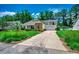Beautiful home with a well-kept lawn, mature trees, and a spacious driveway at 100 Woodlyn Ave., Little River, SC 29566