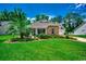 Charming home with stone accents, a well-maintained lawn, and vibrant landscaping at 100 Woodlyn Ave., Little River, SC 29566