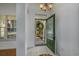 Inviting foyer with tiled flooring, a decorative front door, and natural light at 100 Woodlyn Ave., Little River, SC 29566