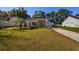 Beautiful single-Gathering home featuring stone accents, a manicured lawn, and a welcoming front porch at 100 Woodlyn Ave., Little River, SC 29566