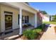 Inviting front porch with beautiful stone features, cozy seating, and a welcoming entrance at 100 Woodlyn Ave., Little River, SC 29566