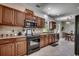 Charming kitchen featuring wood cabinetry, stainless steel appliances, and tiled backsplash at 100 Woodlyn Ave., Little River, SC 29566