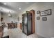 Bright kitchen with stainless steel refrigerator, breakfast table, and decorative wall art at 100 Woodlyn Ave., Little River, SC 29566