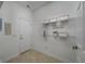 Bright laundry room with storage shelves and convenient access to other areas at 100 Woodlyn Ave., Little River, SC 29566
