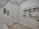 Functional laundry room with shelving, storage containers, and a door to the outside at 100 Woodlyn Ave., Little River, SC 29566