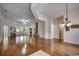 Spacious living room with hardwood floors, high ceilings, and ample natural light from large windows at 100 Woodlyn Ave., Little River, SC 29566