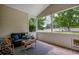 Cozy screened patio with comfortable seating and views of a lush backyard at 100 Woodlyn Ave., Little River, SC 29566