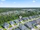 Aerial view of a neighborhood with a pond surrounded by trees at 1007 Longwood Bluffs Circle, Murrells Inlet, SC 29576