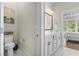 Bright bathroom with marble floors, vanity, and a glimpse of the main bedroom at 1007 Longwood Bluffs Circle, Murrells Inlet, SC 29576