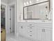 Bright bathroom with double vanity, white cabinetry, and marble floors at 1007 Longwood Bluffs Circle, Murrells Inlet, SC 29576
