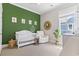 Bright Bedroom with modern crib, neutral walls and green accent wall at 1007 Longwood Bluffs Circle, Murrells Inlet, SC 29576