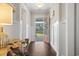 Inviting foyer boasts hardwood floors, wainscoting, and a decorative wood table with a view through the open front door at 1007 Longwood Bluffs Circle, Murrells Inlet, SC 29576