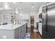 Kitchen boasts a large island with sink, stainless appliances, white cabinets, and a walk-in pantry at 1007 Longwood Bluffs Circle, Murrells Inlet, SC 29576