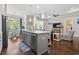 Open-concept living showcasing the kitchen island, stainless steel appliances and view to the living room and sunroom at 1007 Longwood Bluffs Circle, Murrells Inlet, SC 29576
