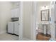 Well-equipped laundry room with modern appliances, storage cabinets, and access to half bath at 1007 Longwood Bluffs Circle, Murrells Inlet, SC 29576