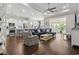 Open-concept living space with hardwood floors, a tray ceiling, and seamless transition to the kitchen and breakfast nook at 1007 Longwood Bluffs Circle, Murrells Inlet, SC 29576