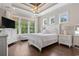 Bright main bedroom boasts large windows, hardwood floors, and neutral tones at 1007 Longwood Bluffs Circle, Murrells Inlet, SC 29576