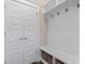 Mudroom with bench, hooks, storage baskets and double doors at 1007 Longwood Bluffs Circle, Murrells Inlet, SC 29576