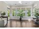 Relaxing sunroom featuring hardwood floors, neutral decor, and abundant natural light at 1007 Longwood Bluffs Circle, Murrells Inlet, SC 29576
