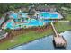 Aerial view highlighting community pool, splash pad, playground, and lake with fishing pier at 101 Culpepper Way # 1007, Myrtle Beach, SC 29579