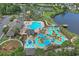 Aerial view features a resort-style pool, water park, and lake in a vibrant community at 101 Culpepper Way # 1007, Myrtle Beach, SC 29579