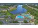 Aerial view showcases the community pool, lake, and surrounding neighborhood at 101 Culpepper Way # 1007, Myrtle Beach, SC 29579