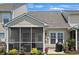 Enjoy outdoor living with this screened porch, a patio area, and lush landscaping, perfect for relaxation at 101 Culpepper Way # 1007, Myrtle Beach, SC 29579