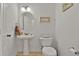 Cozy half-bathroom featuring a pedestal sink, toilet, and decorative wall art at 101 Culpepper Way # 1007, Myrtle Beach, SC 29579