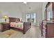 Vaulted ceiling bedroom with luxury wood flooring and large sunny window at 101 Culpepper Way # 1007, Myrtle Beach, SC 29579